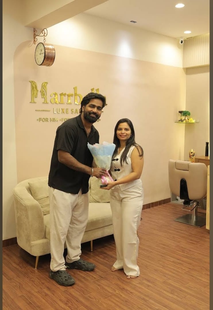 Warm reception lounge with the Marrbella Luxe Salon gold wall signage